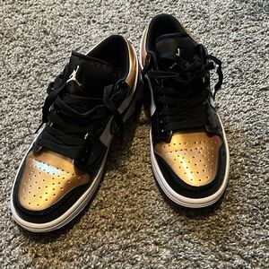 Black and gold Jordan 1s